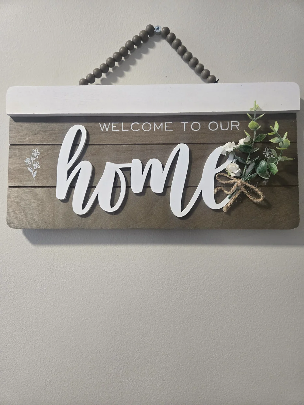 Welcome to Our Home Wooden Wall Sign - White Script on Brown